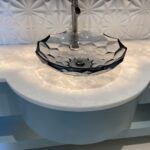 A bathroom with a crystal sink