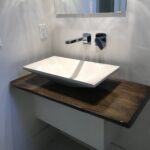 A bathroom with an elevated sink