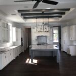 A kitchen with a ceiling fan