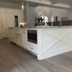 A kitchen counter with shiplap paneling