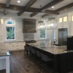 A kitchen with brown marble countertops