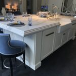 A white counter with a sink