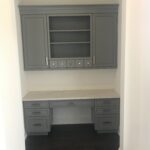 A mounted desk and cupboards