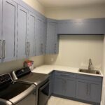 Blue cupboards in a laundry room
