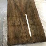 A glossy dark wooden plank